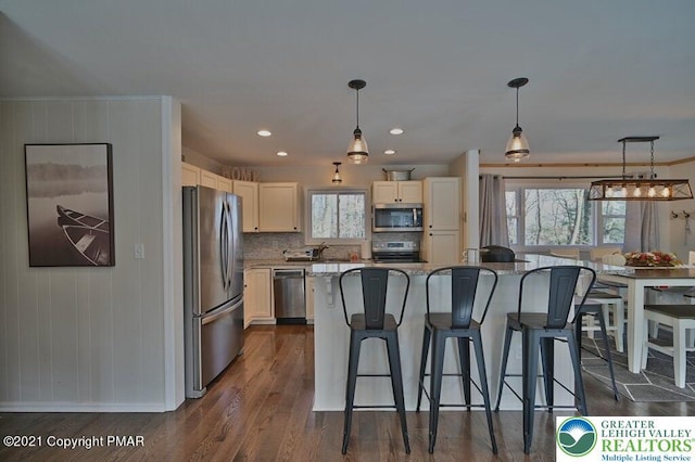 36 Maplewood Rd, Kidder Township S, PA 18624 - kitchen featuring stainless steel appliances, a breakfast bar area, dark wood-type flooring, decorative light fixtures, and tasteful backsplash