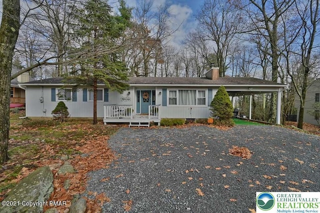 36 Maplewood Rd, Kidder Township S, PA 18624 - ranch-style house featuring a chimney, an attached carport, gravel driveway, and roof with shingles