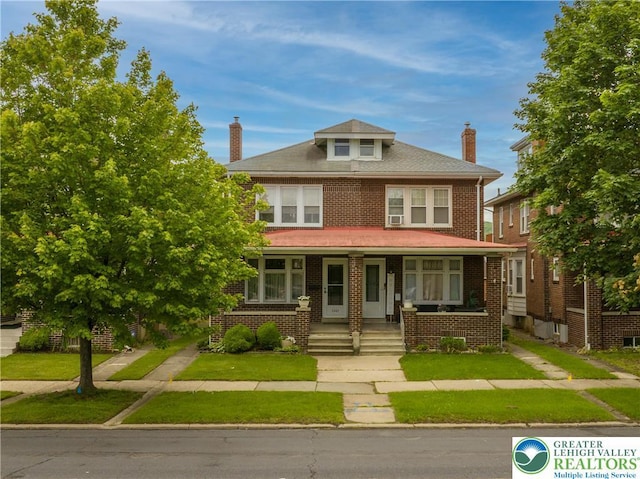 1241 Lehigh St, Allentown City, PA 18103 - traditional style home featuring a porch, a chimney, brick siding, and a front lawn