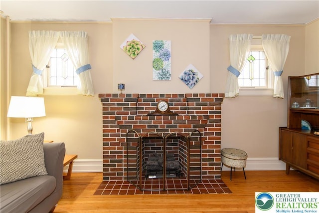 1241 Lehigh St, Allentown City, PA 18103 - living area with baseboards, crown molding, wood finished floors, plenty of natural light, and a fireplace with flush hearth