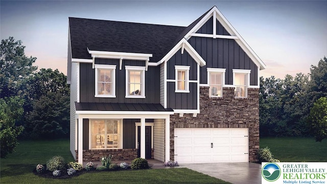 311 Knollwood Dr, Forks Twp, PA 18040 - view of front of property with stone siding, board and batten siding, a yard, and a garage