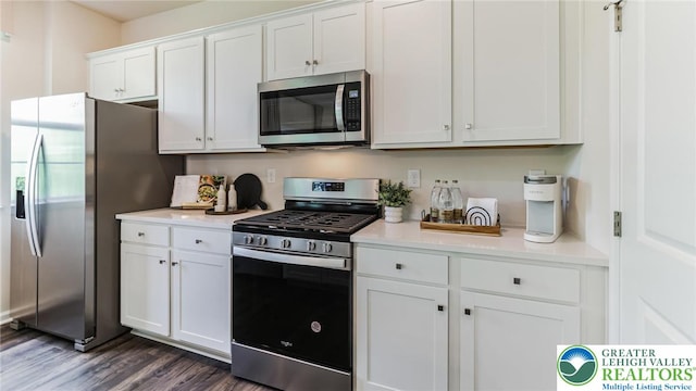 311 Knollwood Dr, Forks Twp, PA 18040 - kitchen featuring appliances with stainless steel finishes, light countertops, dark wood-type flooring, and white cabinets
