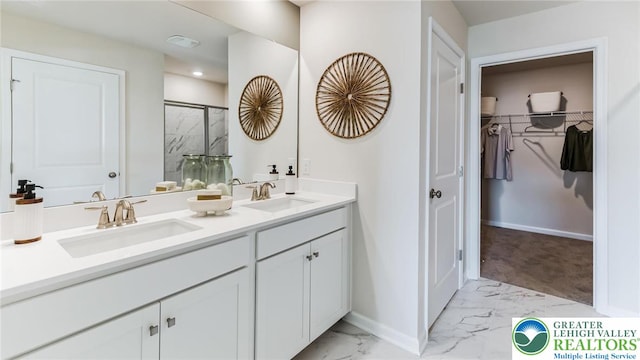 311 Knollwood Dr, Forks Twp, PA 18040 - bathroom featuring marble finish flooring, a shower stall, double vanity, baseboards, and a spacious closet