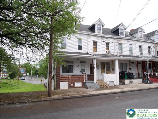 337 N Jordan St, Allentown City, PA 18102 - view of property featuring covered porch, brick siding, and roof with shingles