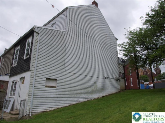 337 N Jordan St, Allentown City, PA 18102 - view of side of property featuring a lawn and a chimney
