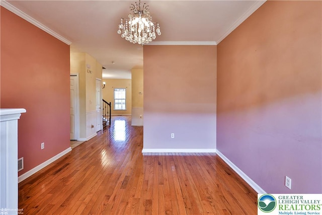 27 Willow Dr, Palmer Twp, PA 18045 - unfurnished room featuring wood-type flooring, a chandelier, baseboards, ornamental molding, and stairway