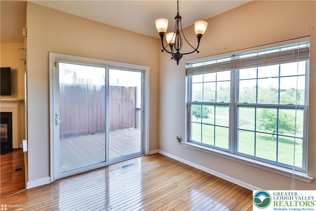27 Willow Dr, Palmer Twp, PA 18045 - unfurnished dining area with a chandelier, baseboards, light wood finished floors, and healthy amount of natural light