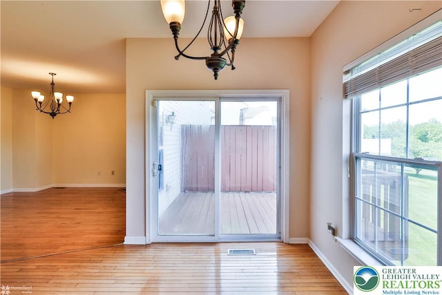 27 Willow Dr, Palmer Twp, PA 18045 - doorway to outside featuring a chandelier, light wood-style flooring, and baseboards