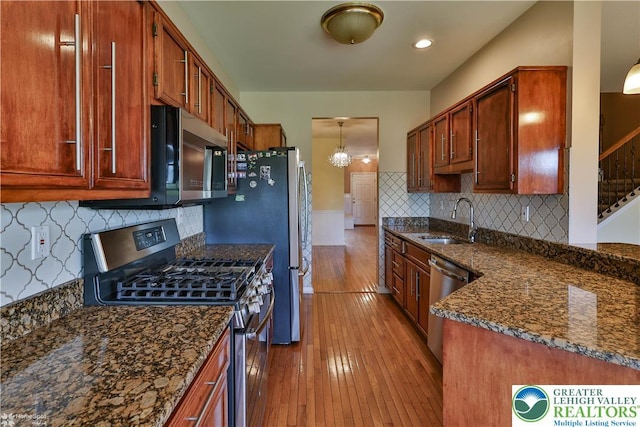 27 Willow Dr, Palmer Twp, PA 18045 - kitchen featuring stainless steel appliances, a sink, dark stone countertops, wood-type flooring, and tasteful backsplash