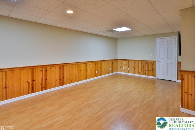 27 Willow Dr, Palmer Twp, PA 18045 - spare room featuring light wood-type flooring, a wainscoted wall, and a drop ceiling