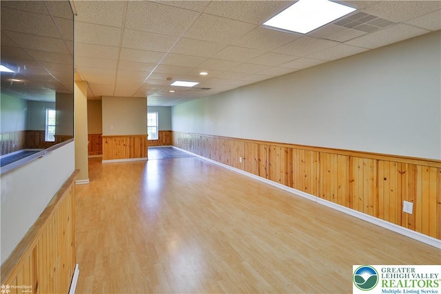 27 Willow Dr, Palmer Twp, PA 18045 - spare room featuring wainscoting, light wood-type flooring, a drop ceiling, and wooden walls