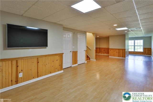 27 Willow Dr, Palmer Twp, PA 18045 - spare room featuring wainscoting, a paneled ceiling, wood finished floors, stairway, and wooden walls