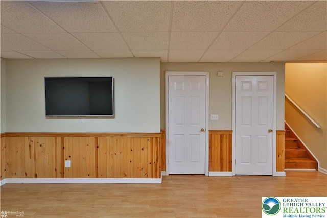 27 Willow Dr, Palmer Twp, PA 18045 - unfurnished room featuring light wood-style flooring, a wainscoted wall, stairway, a paneled ceiling, and baseboards