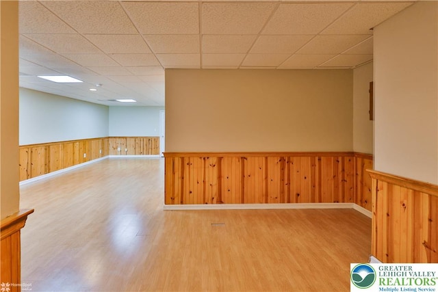 27 Willow Dr, Palmer Twp, PA 18045 - empty room featuring a wainscoted wall, wood finished floors, a drop ceiling, and wooden walls