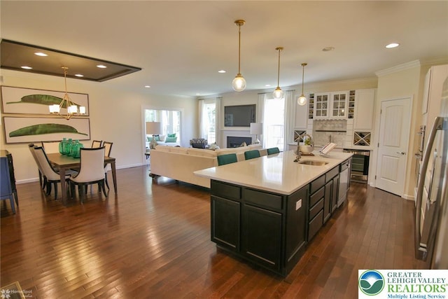 3420 Gentlewind Way Unit Ic 110, Emmaus Borough, PA 18049 - kitchen featuring light countertops, decorative backsplash, dark wood finished floors, a sink, and a fireplace