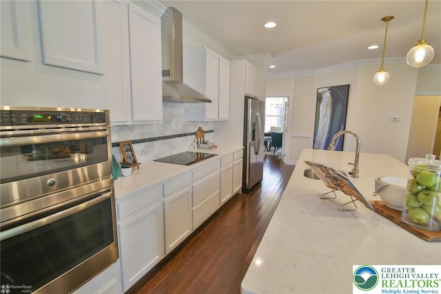 3420 Gentlewind Way Unit Ic 110, Emmaus Borough, PA 18049 - kitchen with appliances with stainless steel finishes, wall chimney exhaust hood, ornamental molding, a sink, and white cabinetry