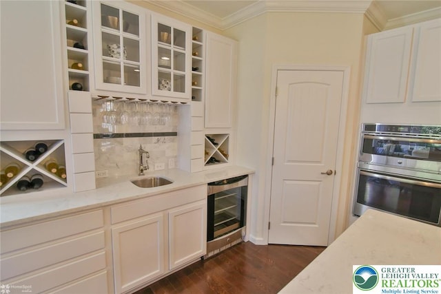 3420 Gentlewind Way Unit Ic 110, Emmaus Borough, PA 18049 - indoor wet bar featuring beverage cooler, ornamental molding, tasteful backsplash, double oven, and dark wood-style floors