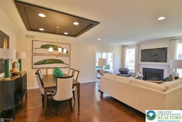 3420 Gentlewind Way Unit Ic 110, Emmaus Borough, PA 18049 - living room with a chandelier, crown molding, dark wood-style floors, recessed lighting, and a glass covered fireplace