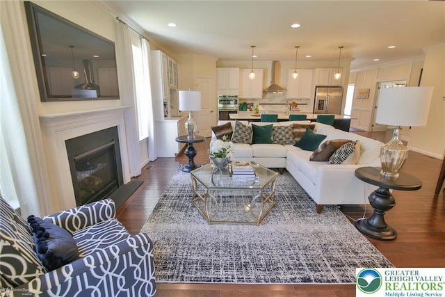 3420 Gentlewind Way Unit Ic 110, Emmaus Borough, PA 18049 - living area with dark wood-style flooring, crown molding, a glass covered fireplace, recessed lighting, and baseboards