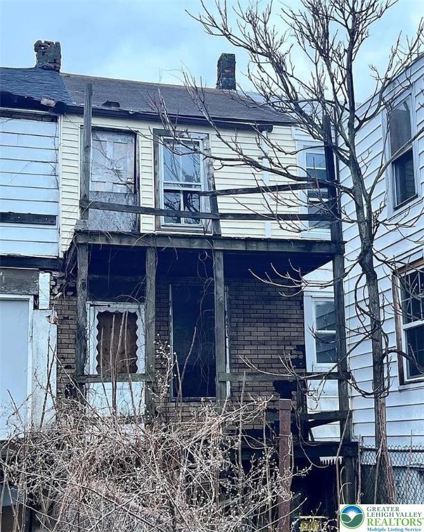 115 N Locust St, Mount Carmel, PA 17851 - view of side of property with a balcony and a chimney