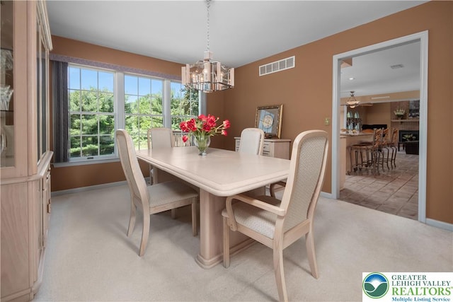 1224 Highland Dr, Upper Macungie Twp, PA 18069 - dining area featuring light carpet, a chandelier, and baseboards