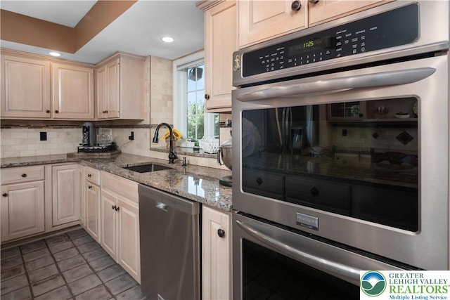 1224 Highland Dr, Upper Macungie Twp, PA 18069 - kitchen featuring a sink, appliances with stainless steel finishes, backsplash, light stone countertops, and recessed lighting