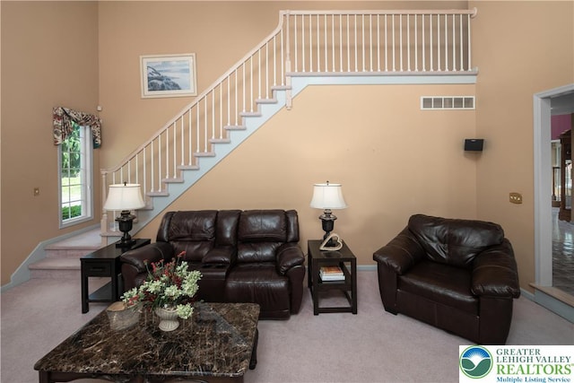 1224 Highland Dr, Upper Macungie Twp, PA 18069 - living room featuring carpet flooring, a high ceiling, stairs, and baseboards
