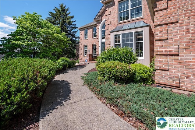 1224 Highland Dr, Upper Macungie Twp, PA 18069 - view of exterior entry featuring a standing seam roof, brick siding, and metal roof