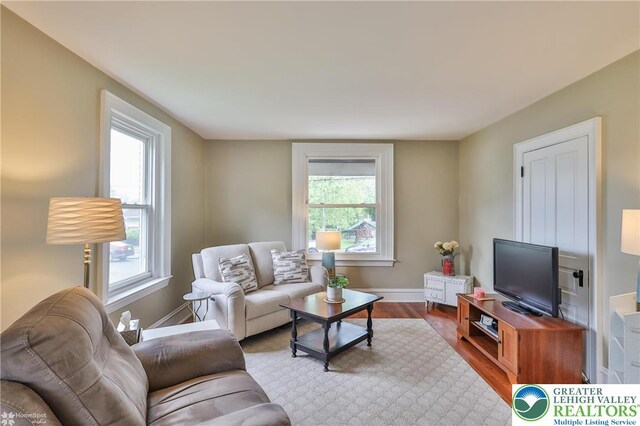 1116 Juniper St, Quakertown Boro, PA 18951 - living area with healthy amount of natural light, baseboards, and wood finished floors