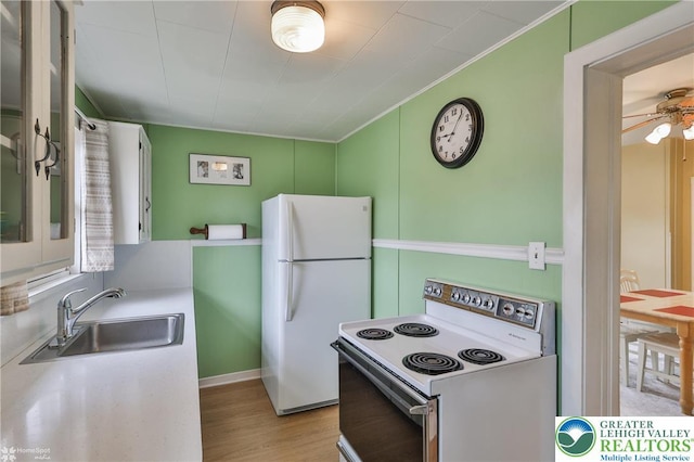 1116 Juniper St, Quakertown Boro, PA 18951 - kitchen featuring white appliances, a sink, light wood finished floors, crown molding, and a ceiling fan