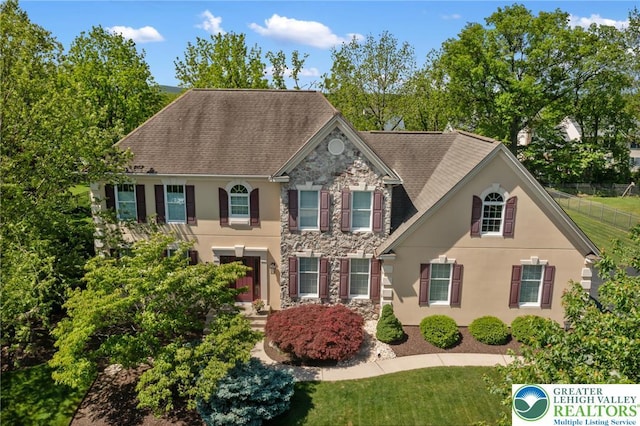 168 Forsythia Ln, Upper Macungie Twp, PA 18104 - view of front of house featuring stone siding, stucco siding, and roof with shingles