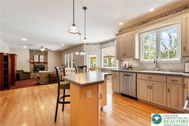 168 Forsythia Ln, Upper Macungie Twp, PA 18104 - kitchen featuring dishwasher, a sink, a stone fireplace, a kitchen breakfast bar, and a ceiling fan