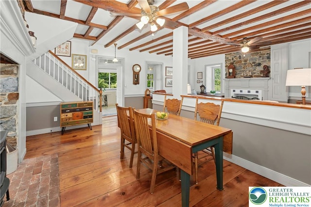 3139 Wilson Ave, Bethlehem Twp, PA 18020 - dining space featuring a ceiling fan, a fireplace, stairway, wood-type flooring, and beam ceiling