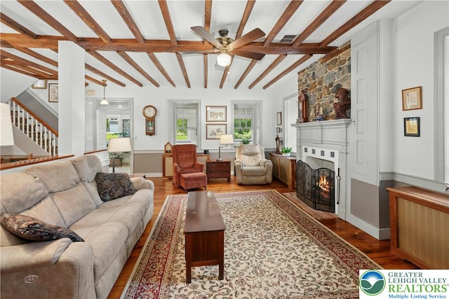 3139 Wilson Ave, Bethlehem Twp, PA 18020 - living room featuring wood finished floors, ceiling fan, a fireplace with flush hearth, stairs, and beamed ceiling