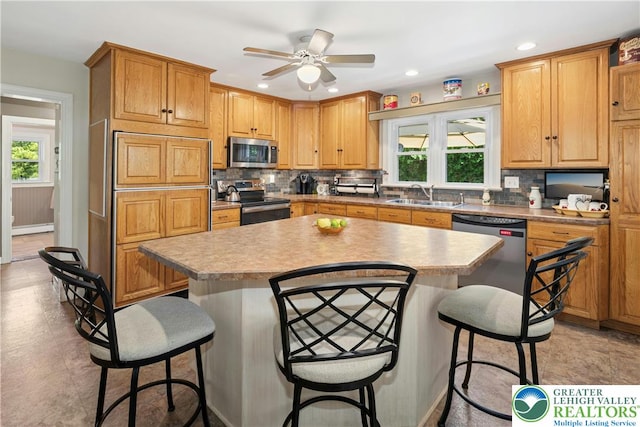 3139 Wilson Ave, Bethlehem Twp, PA 18020 - kitchen with appliances with stainless steel finishes, a sink, plenty of natural light, a kitchen breakfast bar, and recessed lighting