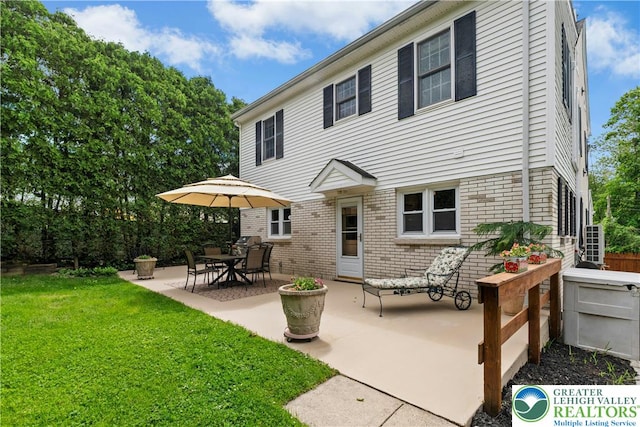3139 Wilson Ave, Bethlehem Twp, PA 18020 - rear view of house featuring brick siding, a yard, and a patio area