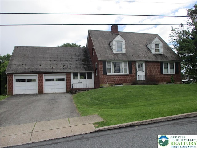 244 High St, Tatamy Borough, PA 18085 - cape cod house with an attached garage, asphalt driveway, and brick siding