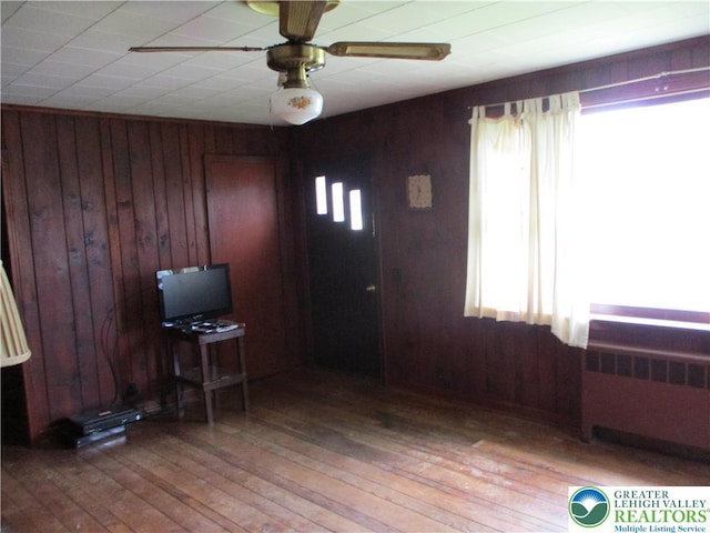 244 High St, Tatamy Borough, PA 18085 - entryway with radiator heating unit, plenty of natural light, wooden walls, and hardwood / wood-style floors