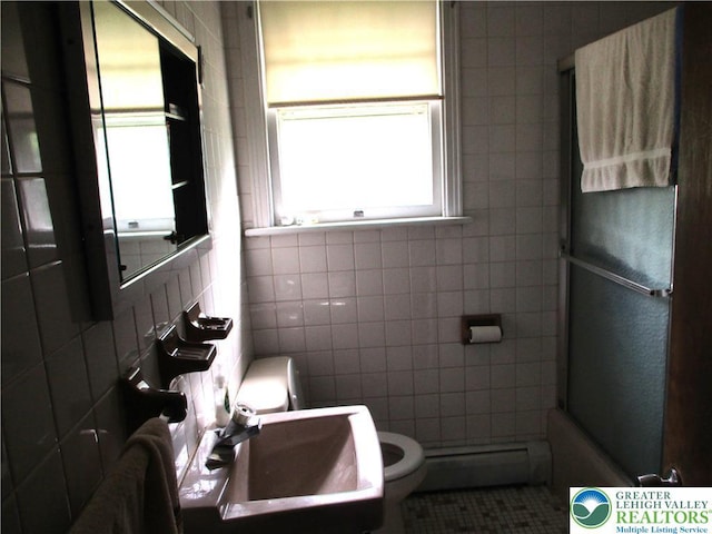 244 High St, Tatamy Borough, PA 18085 - full bath with a baseboard radiator, toilet, a sink, tile walls, and tile patterned floors