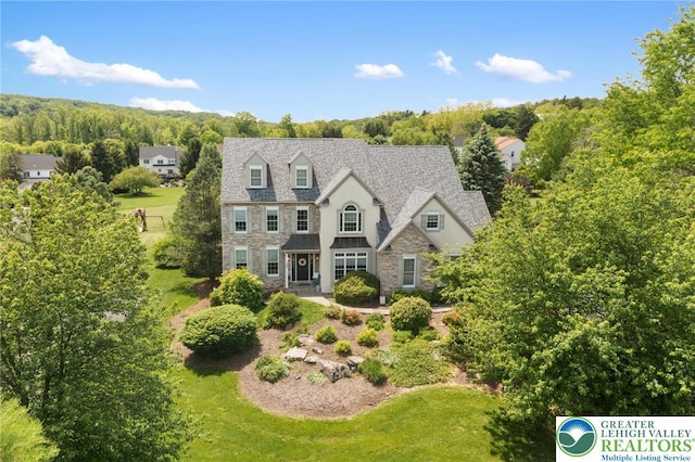 6100 Whitetail Dr, Upper Saucon Twp, PA 18036 - view of front facade featuring stone siding and a front yard