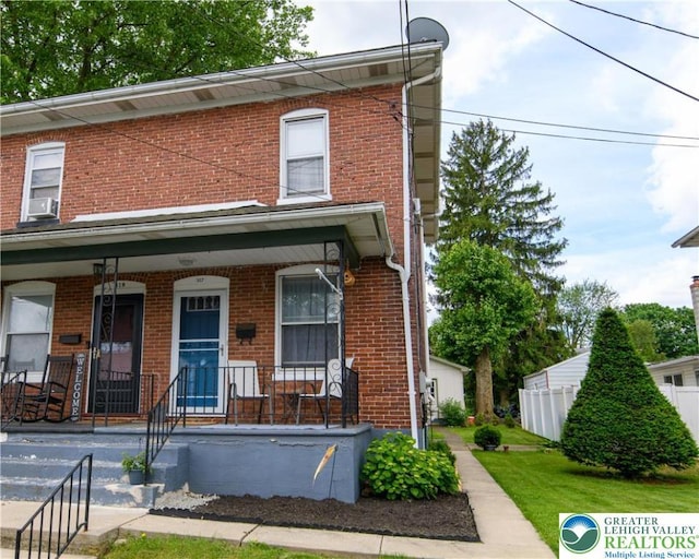 317 Berks St, Easton, PA 18045 - view of property featuring covered porch, brick siding, and cooling unit