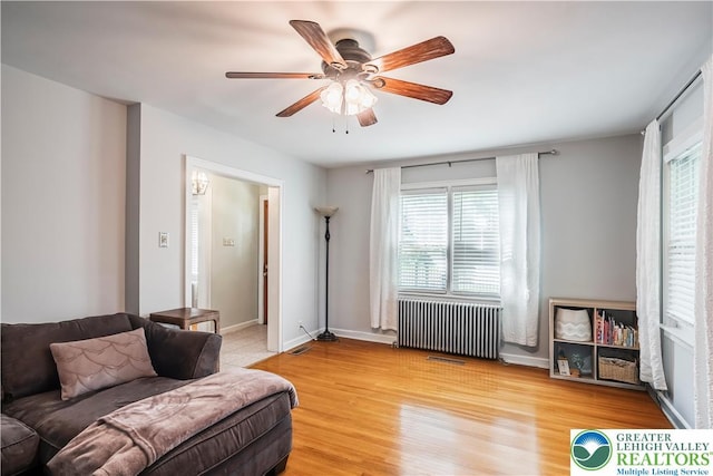 631 Main St, Tatamy Borough, PA 18085 - living area featuring radiator, a ceiling fan, light wood-style flooring, and baseboards