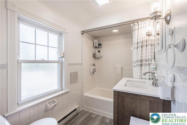 631 Main St, Tatamy Borough, PA 18085 - full bath with a baseboard heating unit, tile walls, toilet, vanity, and tub / shower combination