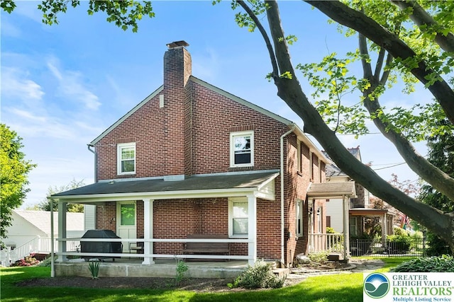 631 Main St, Tatamy Borough, PA 18085 - rear view of house with brick siding and a chimney