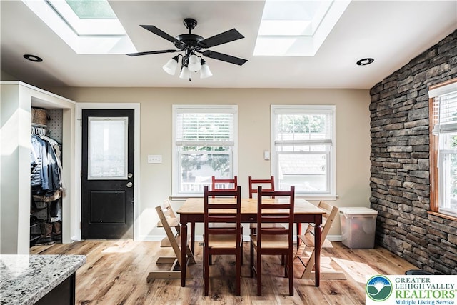 631 Main St, Tatamy Borough, PA 18085 - dining area with a skylight, light wood-style floors, and a ceiling fan