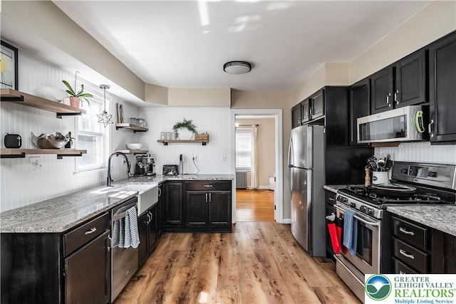 631 Main St, Tatamy Borough, PA 18085 - kitchen featuring stainless steel appliances, open shelves, a sink, and radiator