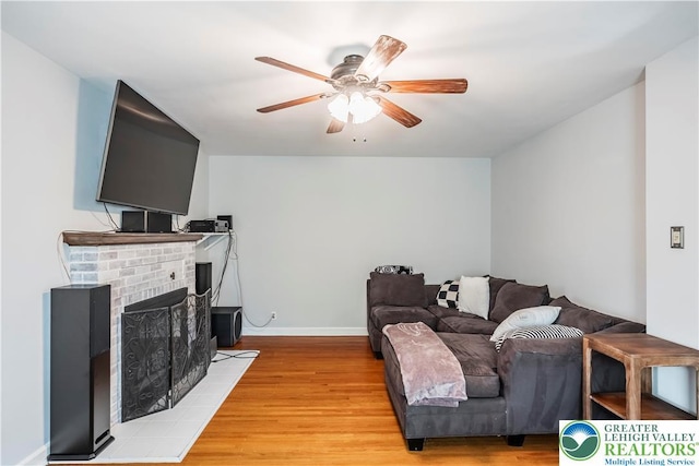 631 Main St, Tatamy Borough, PA 18085 - living room featuring ceiling fan, light wood-type flooring, a fireplace, and baseboards