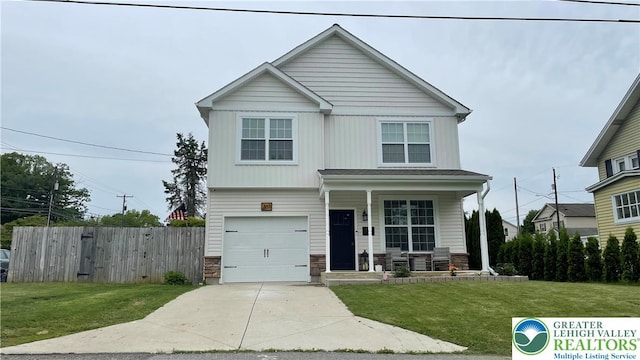 331 Minor St, Emmaus Borough, PA 18049 - view of front of property with covered porch, stone siding, an attached garage, and driveway