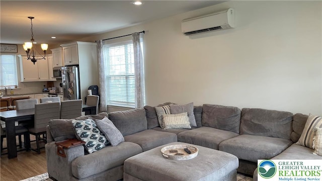 331 Minor St, Emmaus Borough, PA 18049 - living room featuring a wall unit AC, a chandelier, light wood finished floors, and recessed lighting