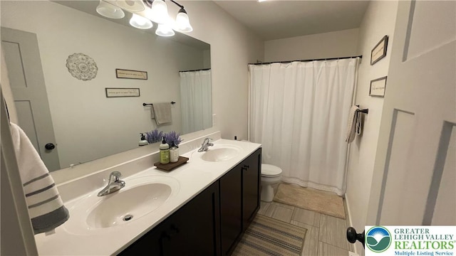 331 Minor St, Emmaus Borough, PA 18049 - bathroom featuring double vanity, toilet, curtained shower, and tile patterned floors